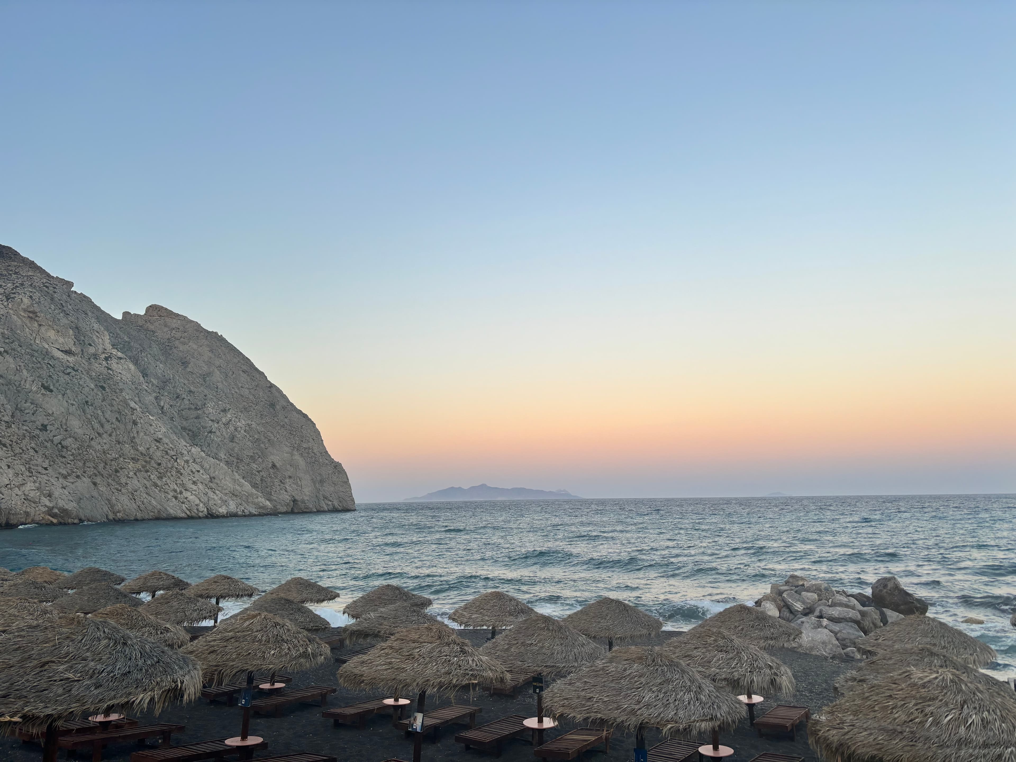 Perissa Beach with Mesa Vouno mountain at sunset in Santorini